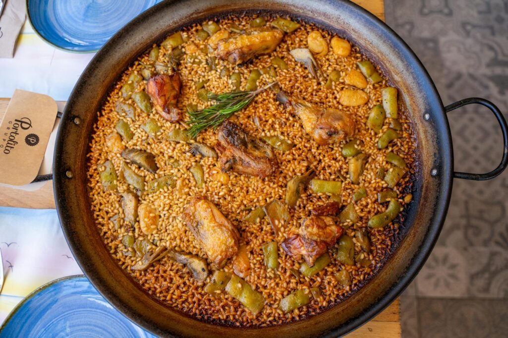 A skillet with shredded chicken, rice, beans, and vegetables cooking together