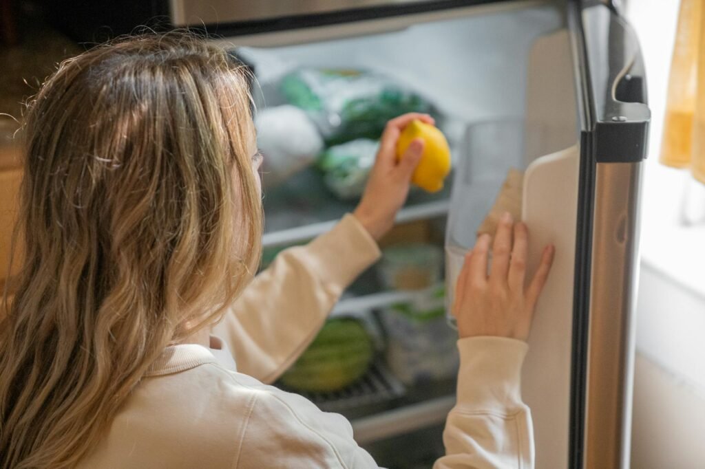 Labeled leftover containers arranged on a refrigerator shelf